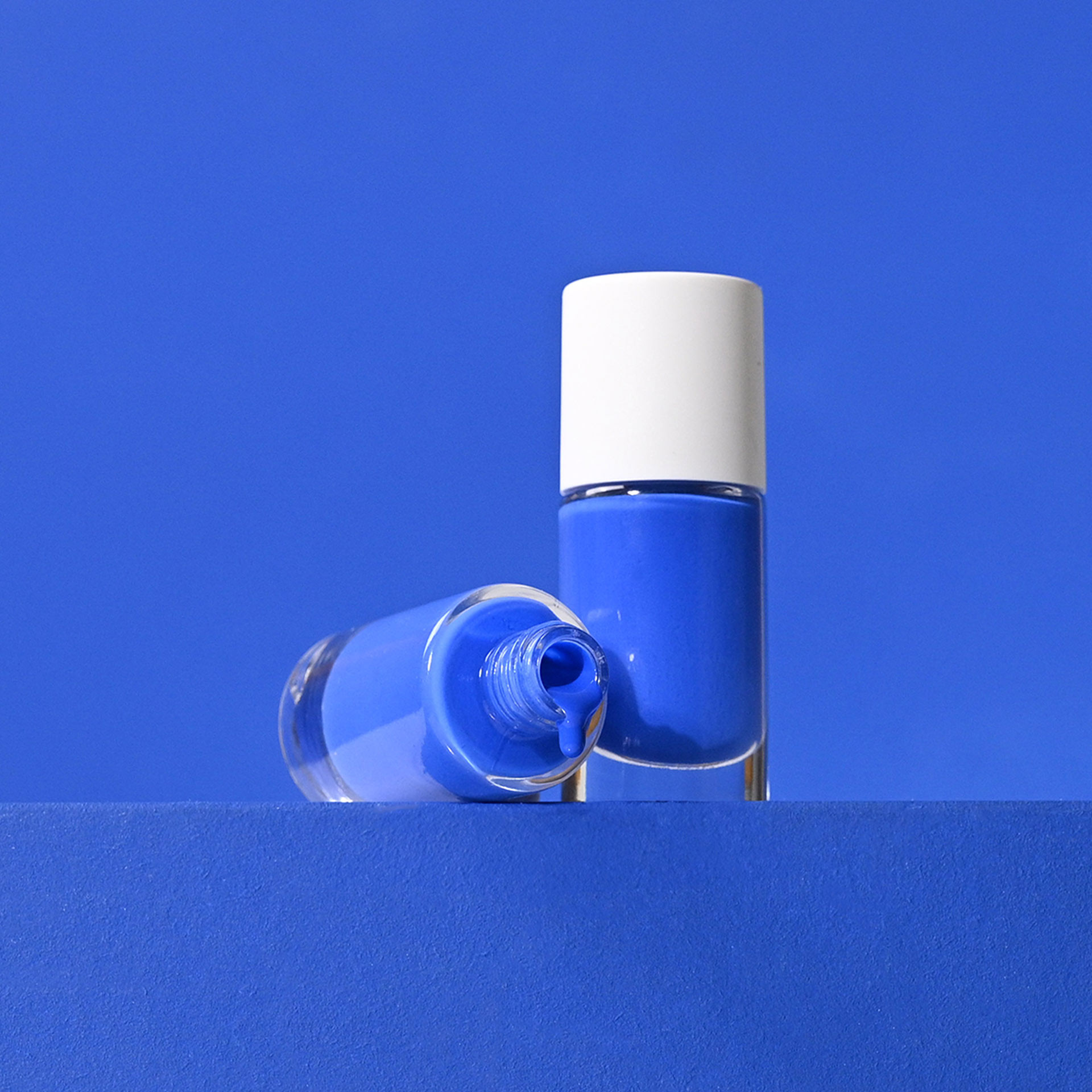 Electric blue Nail Polishes Charlie with open bottle Lifestyle