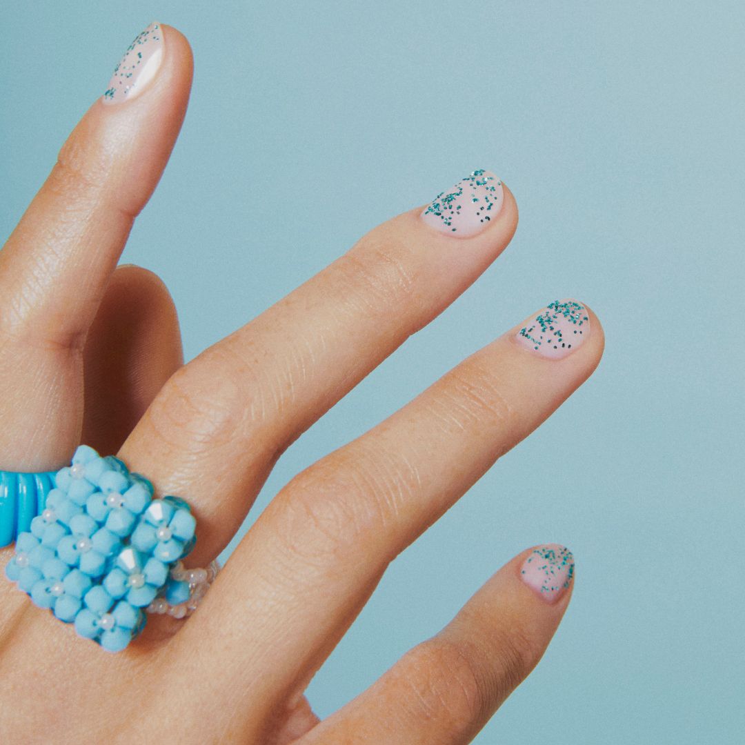 Manucure avec vernis nude avec paillettes biodégradables turquoises
